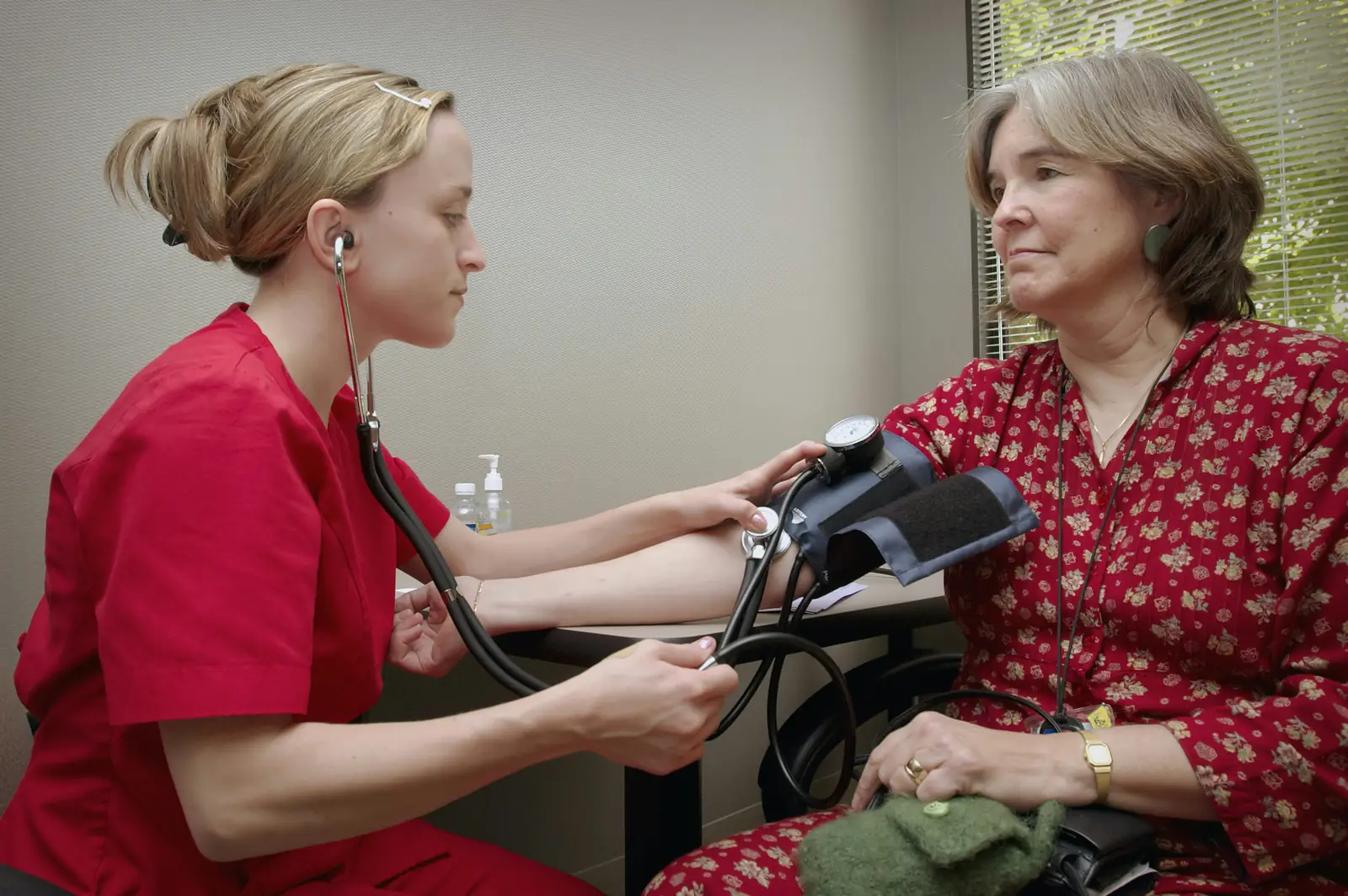 A clinician taking a patient's blood pressure
