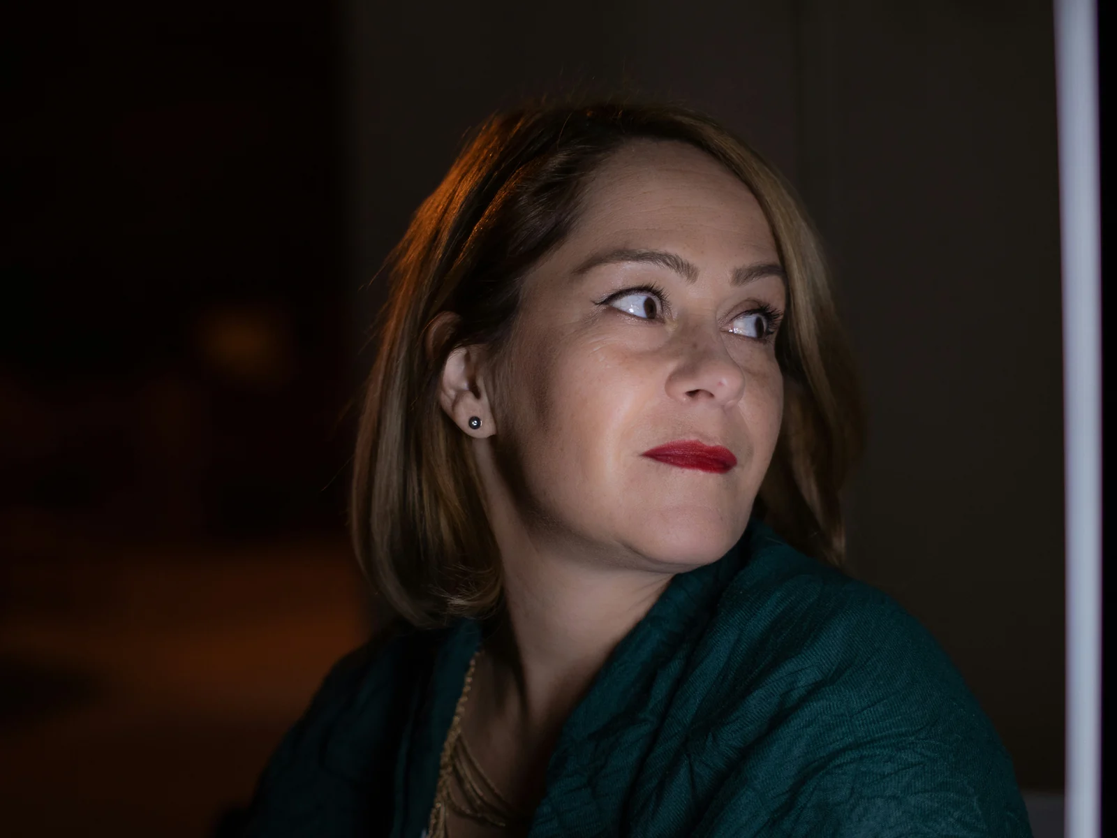 A woman at home during a low evening