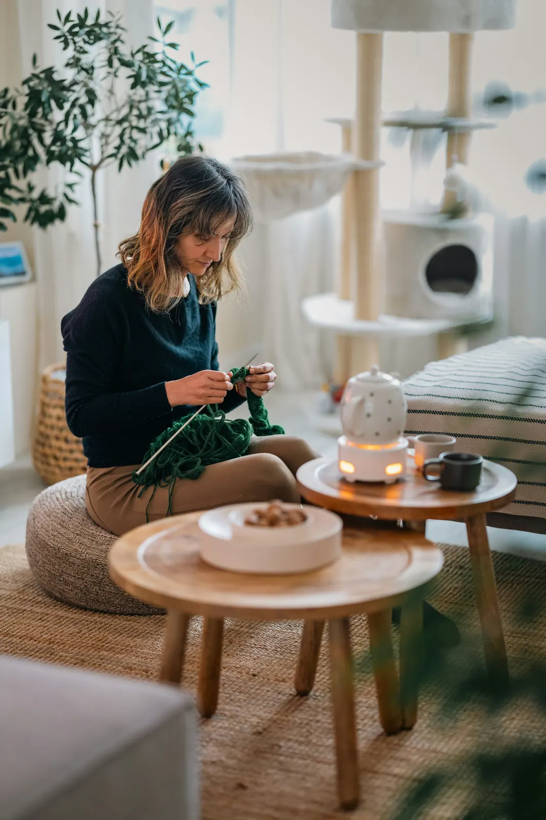 A woman knitting in her front room