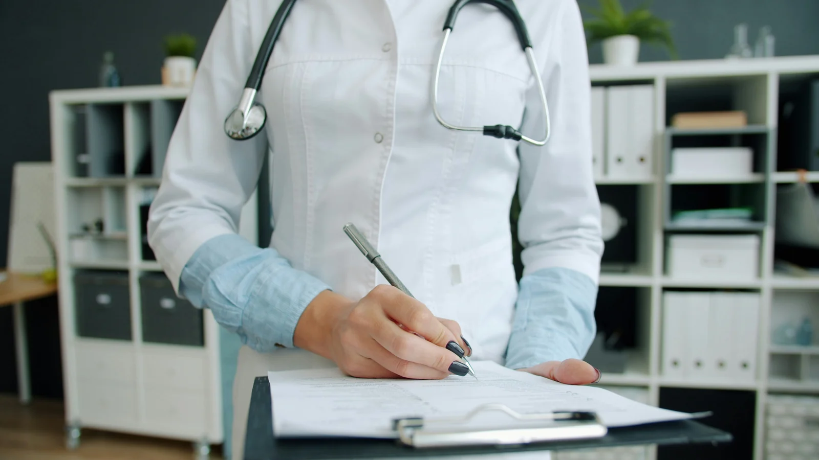 A clinician writing up notes after a visit